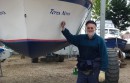 Mort Smith stands beside the bow of Terra Nova