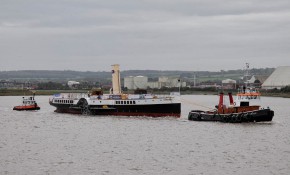 The paddle steamer Medway Queen is towed out of Bristol Docks on her way back to the Medway