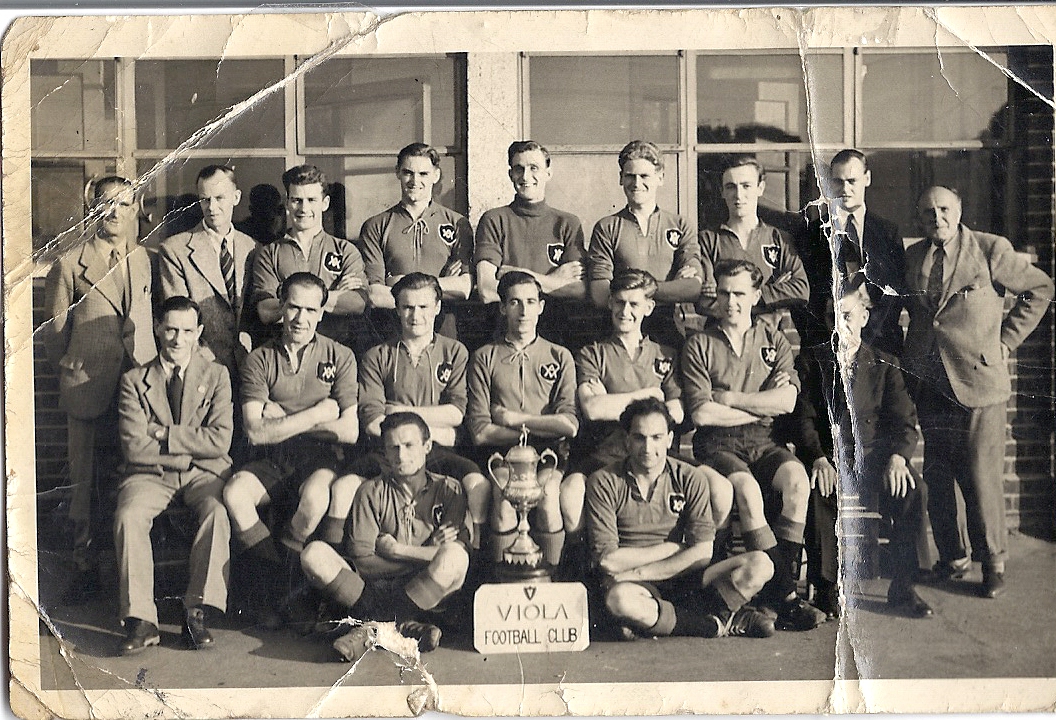 Is this Phil McCarthy? Standing to the right of this photo of the victorious Viola FC is the man known to the team as 'Captain Mac' . Pat Chimes (third from left in the middle row) wondered if this was Dinah Ballantyne's dad