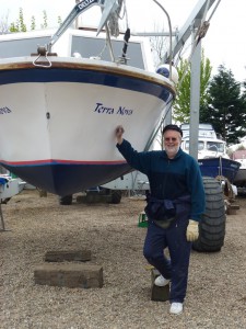 Mort Smith stands beside the bow of Terra Nova